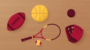 Fußball, Basketball, Tennisschläger und weitere Sportgeräte auf einem Holztisch